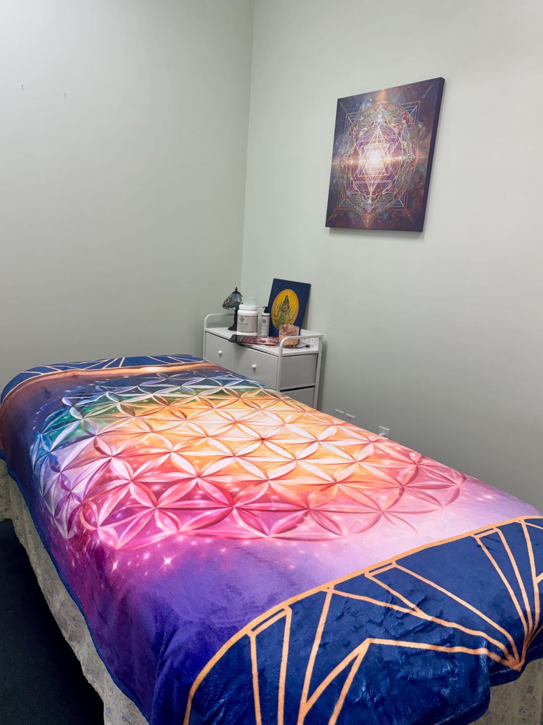 The energy healing room with a flower-of-life covered table